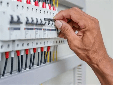 Hand adjusting circuit breaker in electrical panel